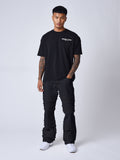 Jeans évasé à détails effilochés